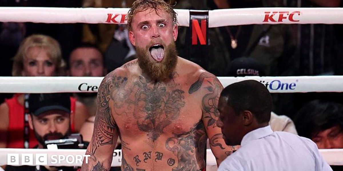 Jake Paul sticks his tongue out during a fight