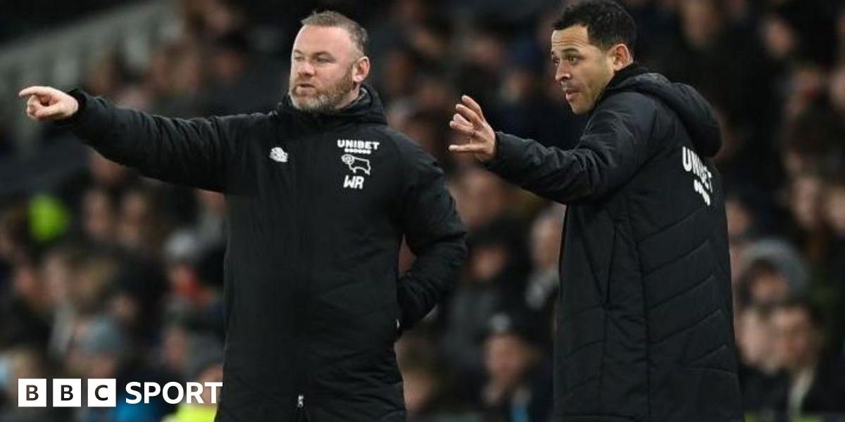 Wayne Rooney and Liam Rosenior on the touchline wearing black Derby County team coats