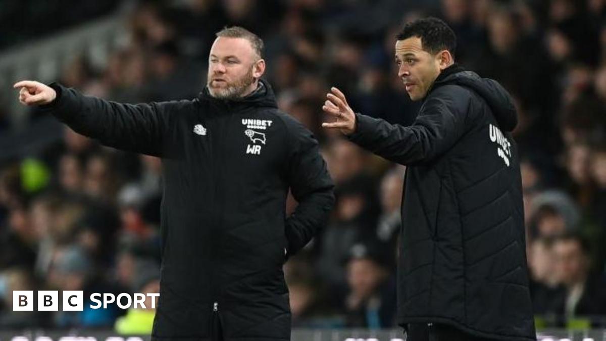 Wayne Rooney and Liam Rosenior on the touchline wearing black Derby County team coats